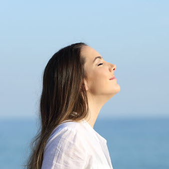 Woman with eyes closed, smiling